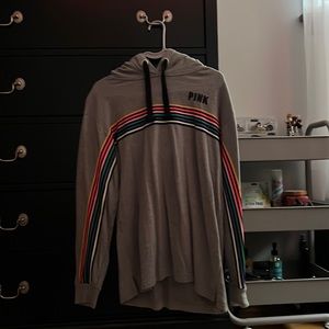 Pink sweatshirt with rainbow lines on the front, worn like two times